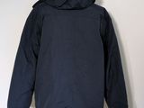the back of a black jacket on a mannequin stand