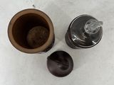 a cup of coffee and a coffee grinder on a table