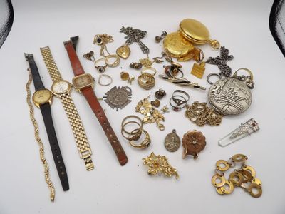 a lot of gold and silver jewelry on a white table