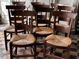 several chairs are arranged in a row on a checkered floor