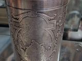 a silver cup sitting on top of a table