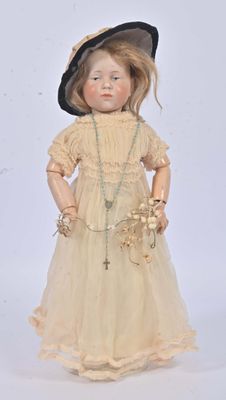 an old fashioned doll with a hat and dress on a white background