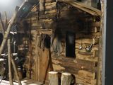 a small wooden house made out of logs and logs