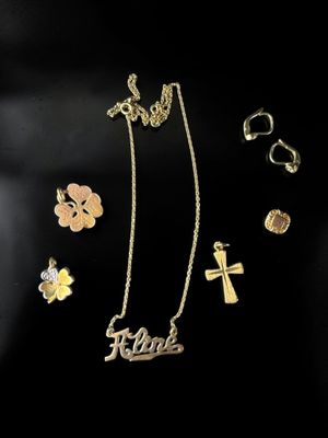une collection de bijoux en or et en argent comprenant une croix, une fleur et une croix