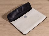 wallet on a wooden table with a button on the front