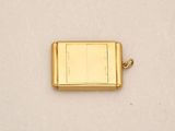 an image of a small gold plated lighter on a white surface