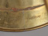 a close up of a gold clock on a table