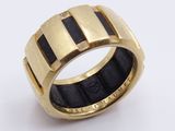 an image of a gold ring with black and white stripes on it