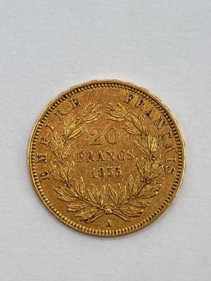 a close up of a gold coin on a white surface