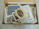 a box full of old books and cards on a table