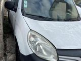 a small white van parked on the side of the street
