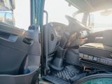 a picture of the inside of a truck with the driver ' s door open