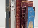 a lot of books that are stacked on top of each other