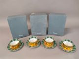 four tea cups and saucers are sitting on a table