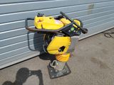 a yellow and black machine that is sitting on the ground