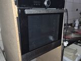 a black oven sitting on top of a counter in a kitchen