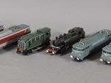 Plusieurs petits trains sont alignés les uns à côté des autres sur une table