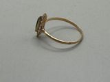 an image of a gold ring with a stone in the middle