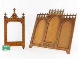two pieces of wood with carvings and a mirror on a white surface