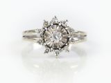 a close up of a diamond ring on a white surface