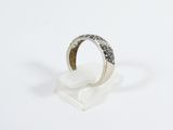 sterling silver ring with black diamonds on a clear acrylic stand