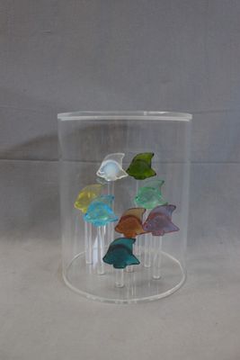 a glass vase with a bunch of butterflies inside of it