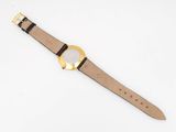 a close up of a watch on a white surface