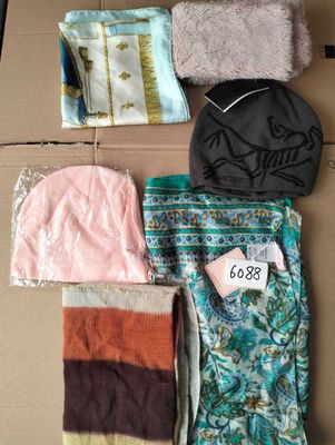 a lot of clothes that are sitting on a cardboard box