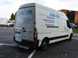 a white van parked in a parking lot next to a building