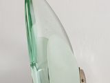 a green glass mirror on the wall next to a white wall