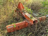 a rusted out machine in the middle of a field