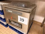 a machine that is sitting on top of crates in a kitchen