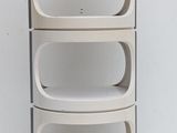 a white shelf that has three shelves on it
