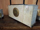 a small clock sitting on top of a wooden table