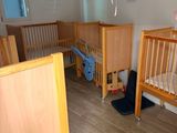 a baby ' s room with two cribs and a bed