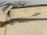 two shotguns are laying on the floor next to a bag