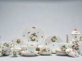 a group of porcelain dishes and cups and saucers
