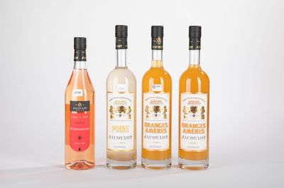 trois bouteilles de vin sont alignées sur une surface blanche
