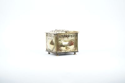 a small silver box with a picture of a woman on it