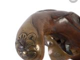 a close up of a bronze statue of a hand holding a baseball bat