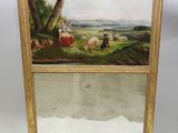 an image of a person holding a mirror with a painting on it