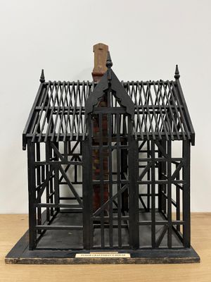 a small metal structure with a wooden structure on top of it