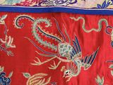 an image of a red and blue bed spread with a bird on it