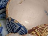 a close up of a plate with a broken bowl on it