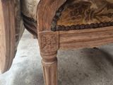 a wooden chair with a floral cushion on it