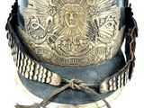 a helmet that has a gold emblem on it