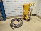 a yellow machine with a hose and a hose attached to it