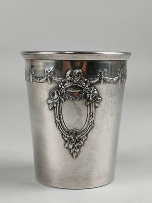 an antique silver cup with a decorative design on the rim