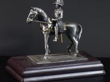 statue of a man on a horse on a wooden base