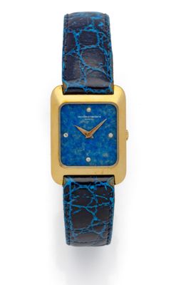 une montre dorée et bleue avec un bracelet en cuir